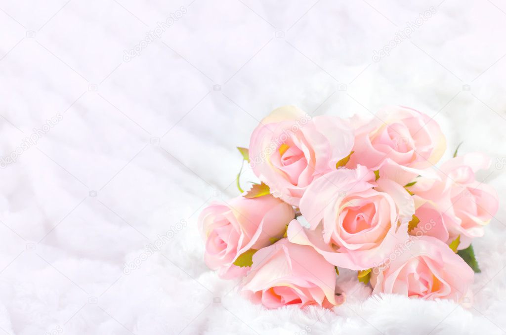 Pastel Coloured Artificial Pink Rose Wedding Bridal Bouquet on white fur background with soft vintage tone