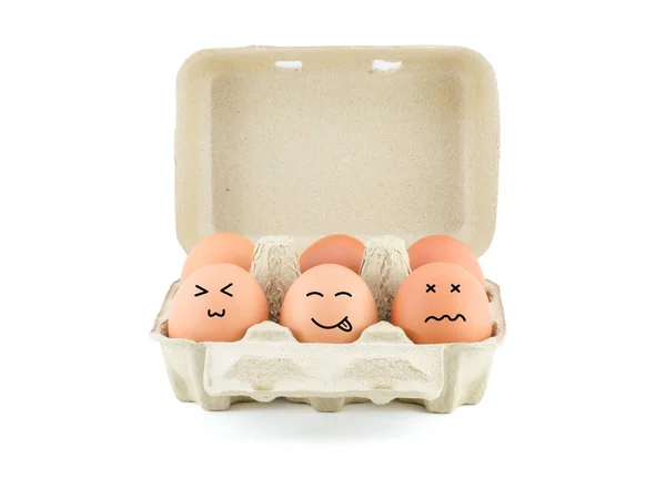 Funny Drawing Faces on Eggs in carton isolate on white with clip — Stock Photo, Image