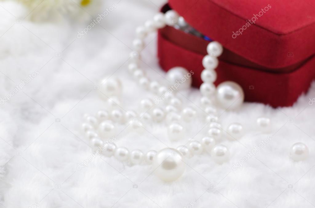 white pearl necklace with red jewel box