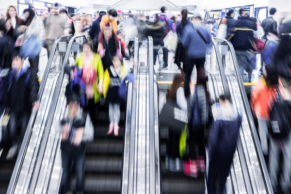 Motion blurred crowd people in shopping mall