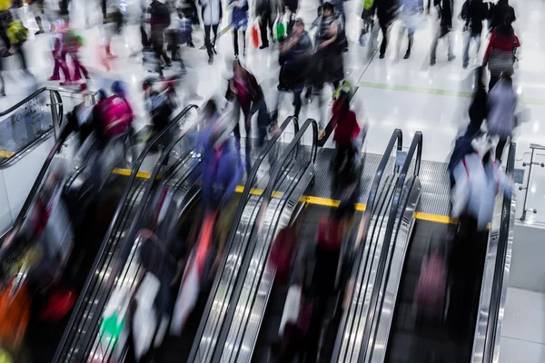 Motion blurred crowded people shopping in mall