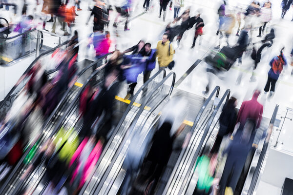 Motion blurred crowded people shopping in mall