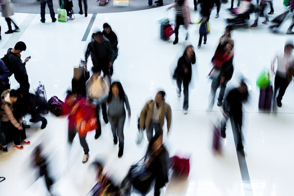 Motion blurred crowded people shopping in mall