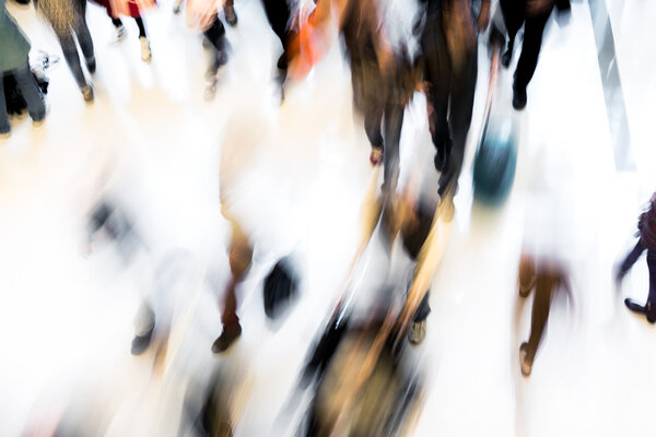 Motion blurred crowded people shopping in mall