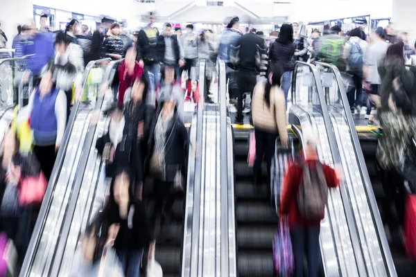 Motion blurred crowded people shopping in mall Stock Photo