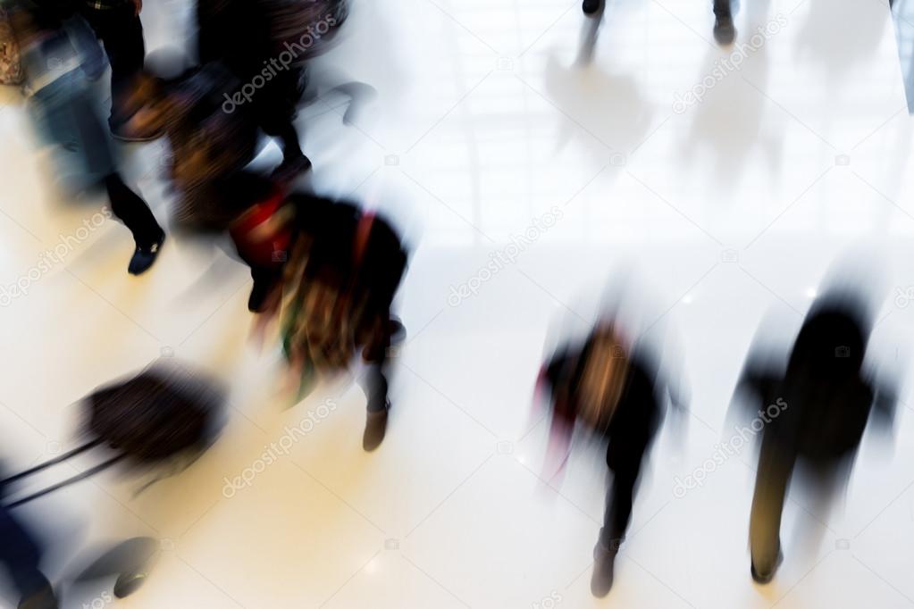 Motion blurred crowded people shopping in mall