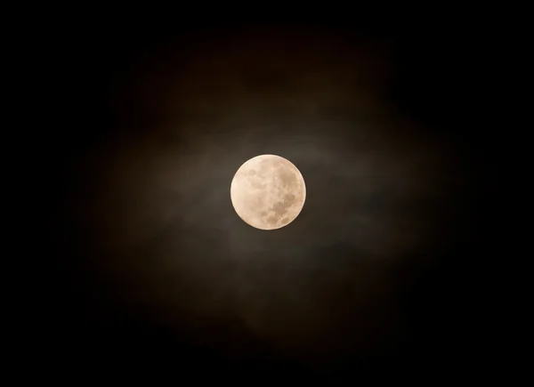 View of the full moon behind fluffy cloud at night — Stock Photo, Image