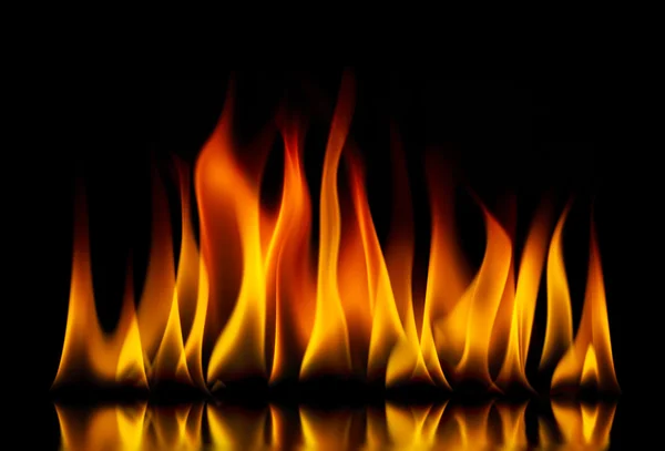 Yellow fire flames on a black — Stock Photo, Image