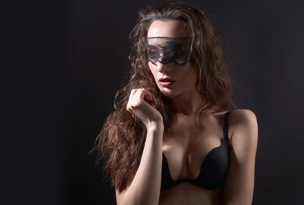 Mulher sexual posando sobre fundo escuro com máscara de renda em olhos fechados — Fotografia de Stock