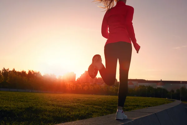 Athlete running woman on the road in morning sunrise training for marathon and fitness — Stock Photo, Image