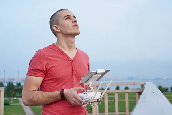 Young man operating a drone remote control console — Stock Photo, Image