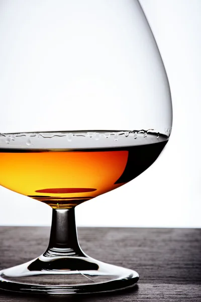 Part of  glass with cognac on white background — Stock Photo, Image