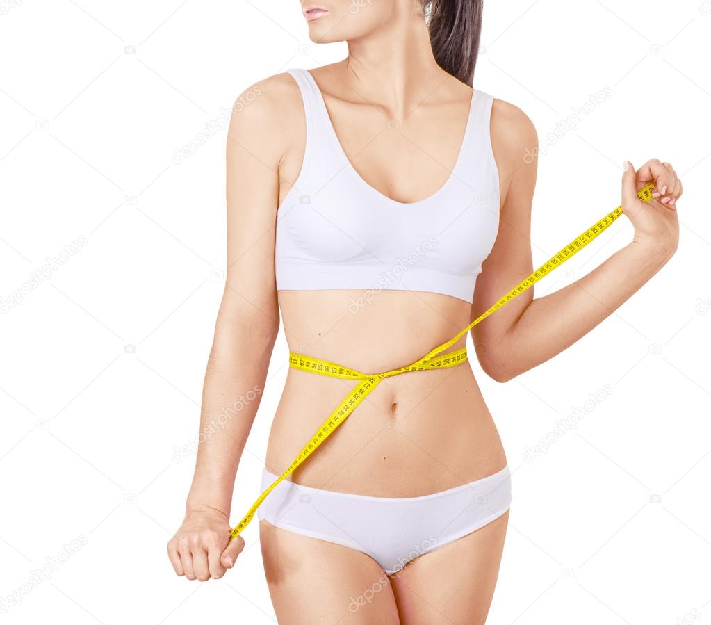 Slim woman in white underwear and measure around her body on isolated background.