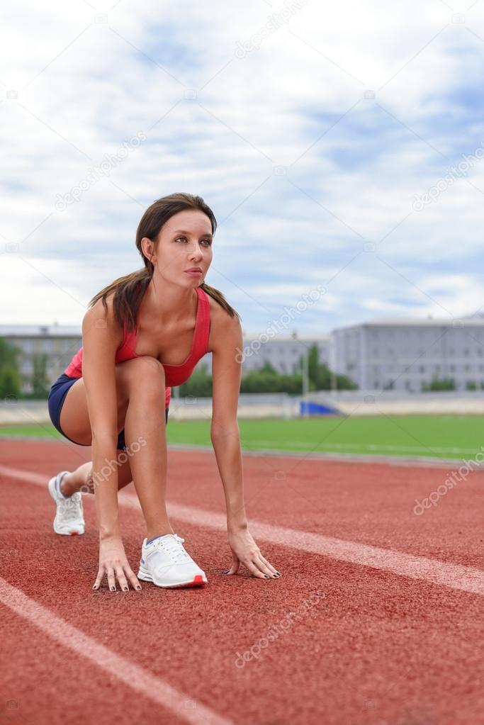 Athlete woman on the starting blocks