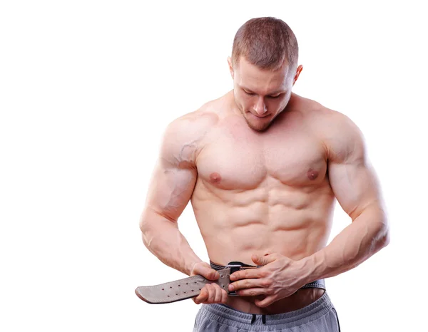 Muscular man fasten lifting belt over white isolated background — Stock Photo, Image