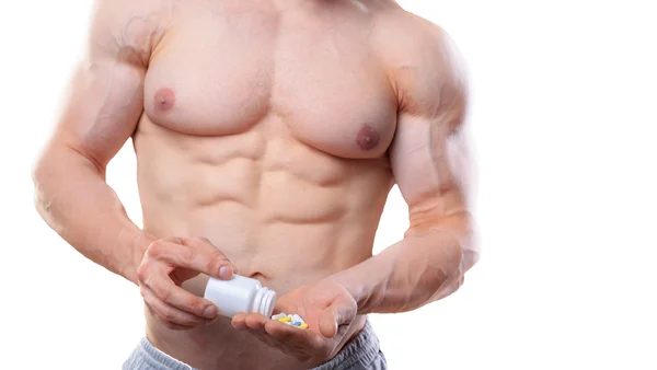 Bodybuilder with jar and pills on isolated white background in studio — Stock Fotó