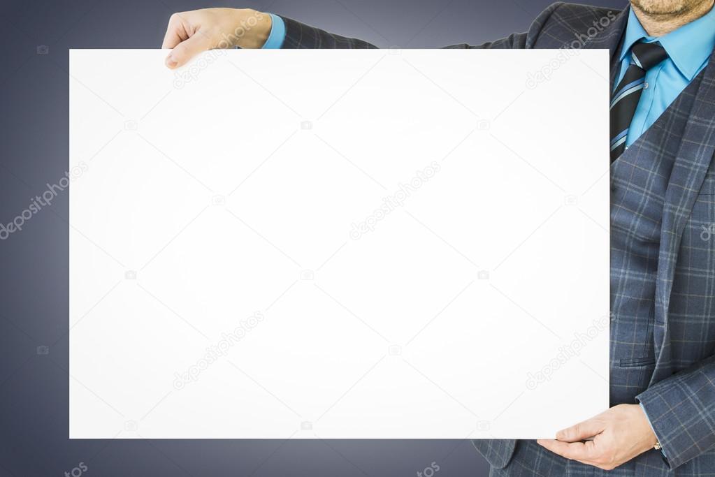 Business man holding poster with room for text and graphic.
