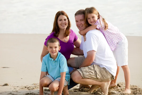 Amorosa familia en la playa —  Fotos de Stock