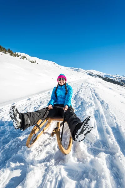 Young woman having fun on a sledge — Stock Photo, Image