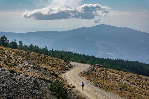 Man practicing sport by bicycle in the summits of Sierra Nevada, Granada.