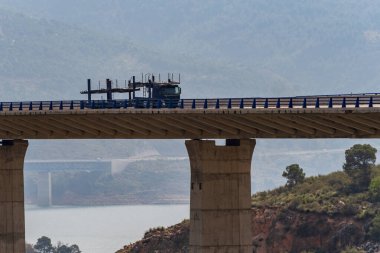 Boş bir araba taşıyıcısı köprüden geçiyor..