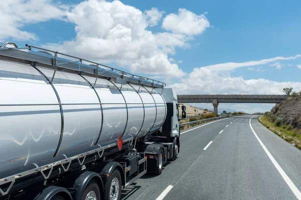 Tank truck with dangerous goods, danger from flammable liquids, driving on the highway.