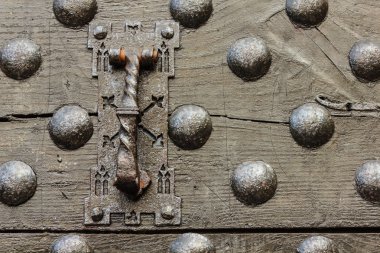 particular of the door  of a castle with its clapper clipart