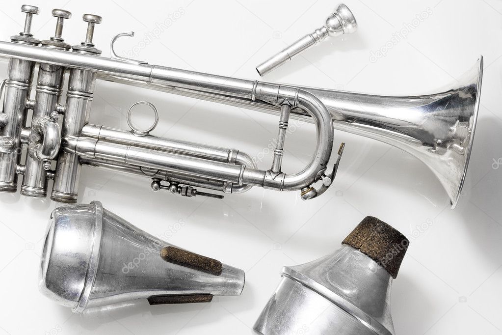 silver trumpet and mute on white background