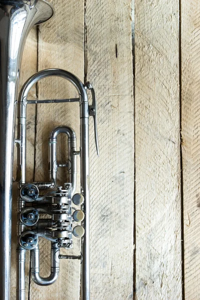 Trumpet on wooden background — Stock Photo, Image