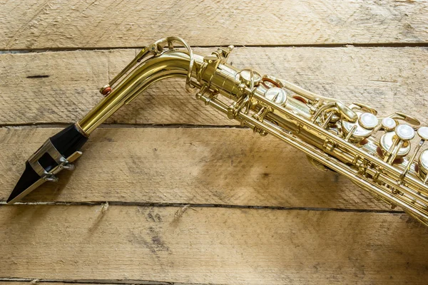 Saxophone on wooden background — Stock Photo, Image