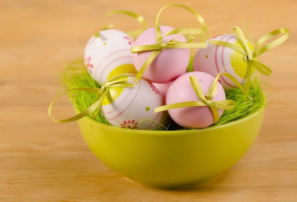 Easter decorative eggs in the green bowl — Stock Photo, Image