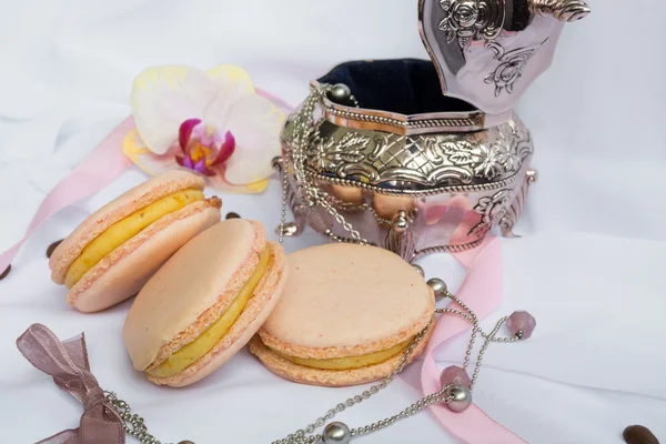 Color macaroons and silver casket on a white background — Stock Photo, Image