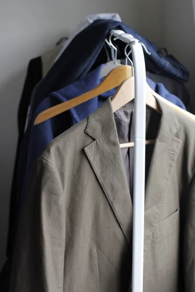 Shirts and jackets in a wardrobe