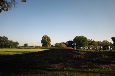 İnsanlar sabahları golf oynuyor.