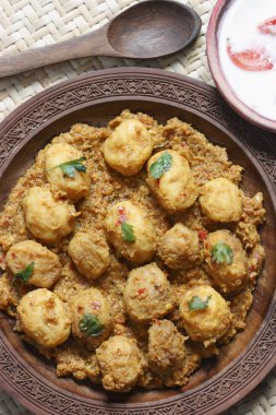 Kashmiri dum aloo made of baby potatoes cooked in yogurt gravy with spices clipart