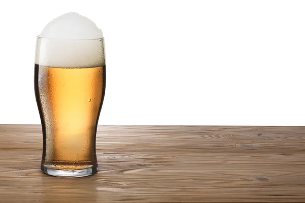 Glass of light beer on wooden table — Stock Photo, Image