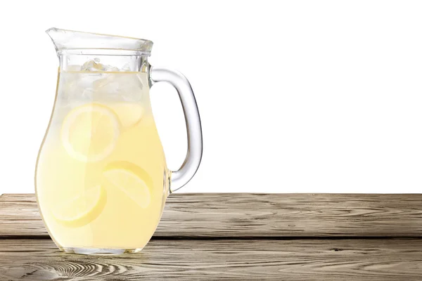 Lemonade pitcher on wooden table — Stock Photo, Image