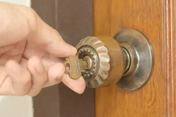 Primer plano de la mano masculina desbloqueando la vieja perilla de la puerta — Foto de Stock