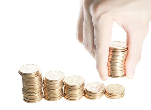 Groep van stapel van een dollar munten in aflopende volgorde van links naar rechts geïsoleerd op wit met hand geven extra stapel dollar munten. Een vertegenwoordiging van de helpende hand. Stockfoto