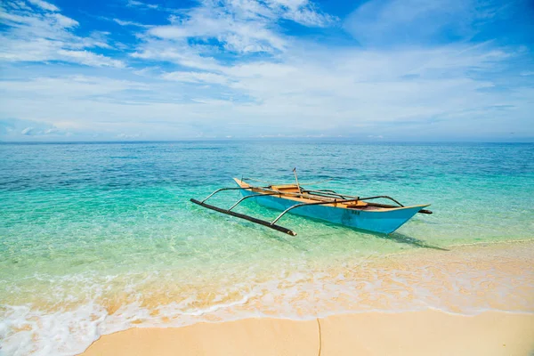 Barco filipino tradicional em uma praia branca no mar — Fotografia de Stock