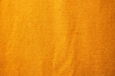 Tekstil malzemesinin altın sarısı arka planı, yakın plan..