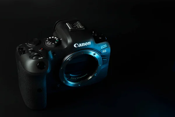 Крупный план цифровой камеры Canon r6, черный фон, блики — стоковое фото