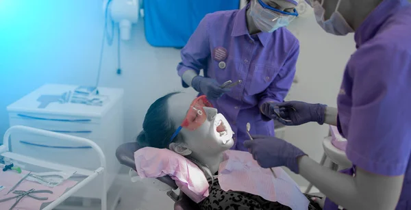 Dentist appointment Ortadont, installation of braces on teeth, patient on the couch — Stock Photo, Image