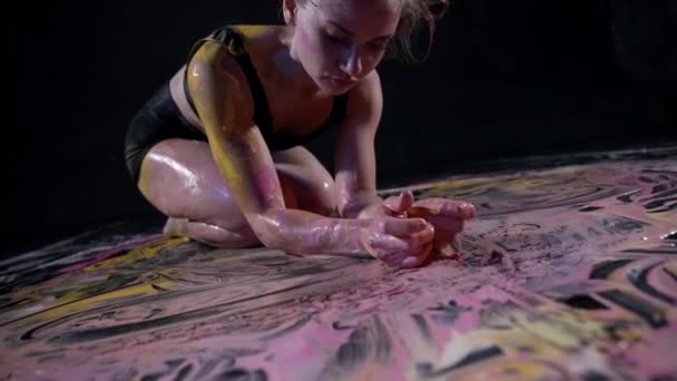 Жінка малює картину з її тілом на підлозі імпровізації — стокове відео