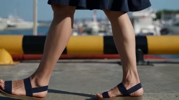 Una mujer caminando al aire libre en sandalias. Primer plano de las piernas vista lateral — Vídeos de Stock