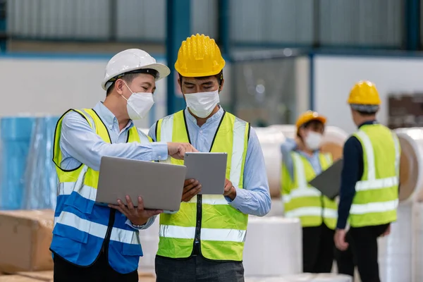 Teamwork engineer in uniform wear protection mask brainstorming workshop industrial factory building. meeting worker team.