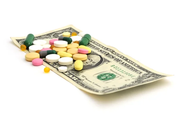 Pillen und Geld - billiges Arzneimittel-Konzept Stockbild