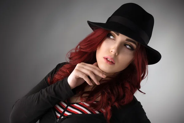 Young redhead wearing a black hat — Stock Photo, Image