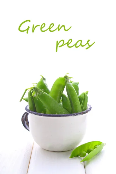 Young peas in a white cup — Stock Photo, Image