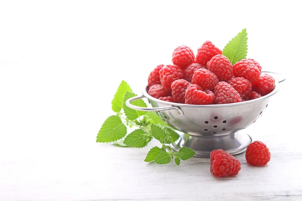 Fresh raspberries in colander — Stock Photo, Image